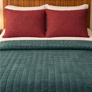 Two standard quilted pillow shams. Burgundy color